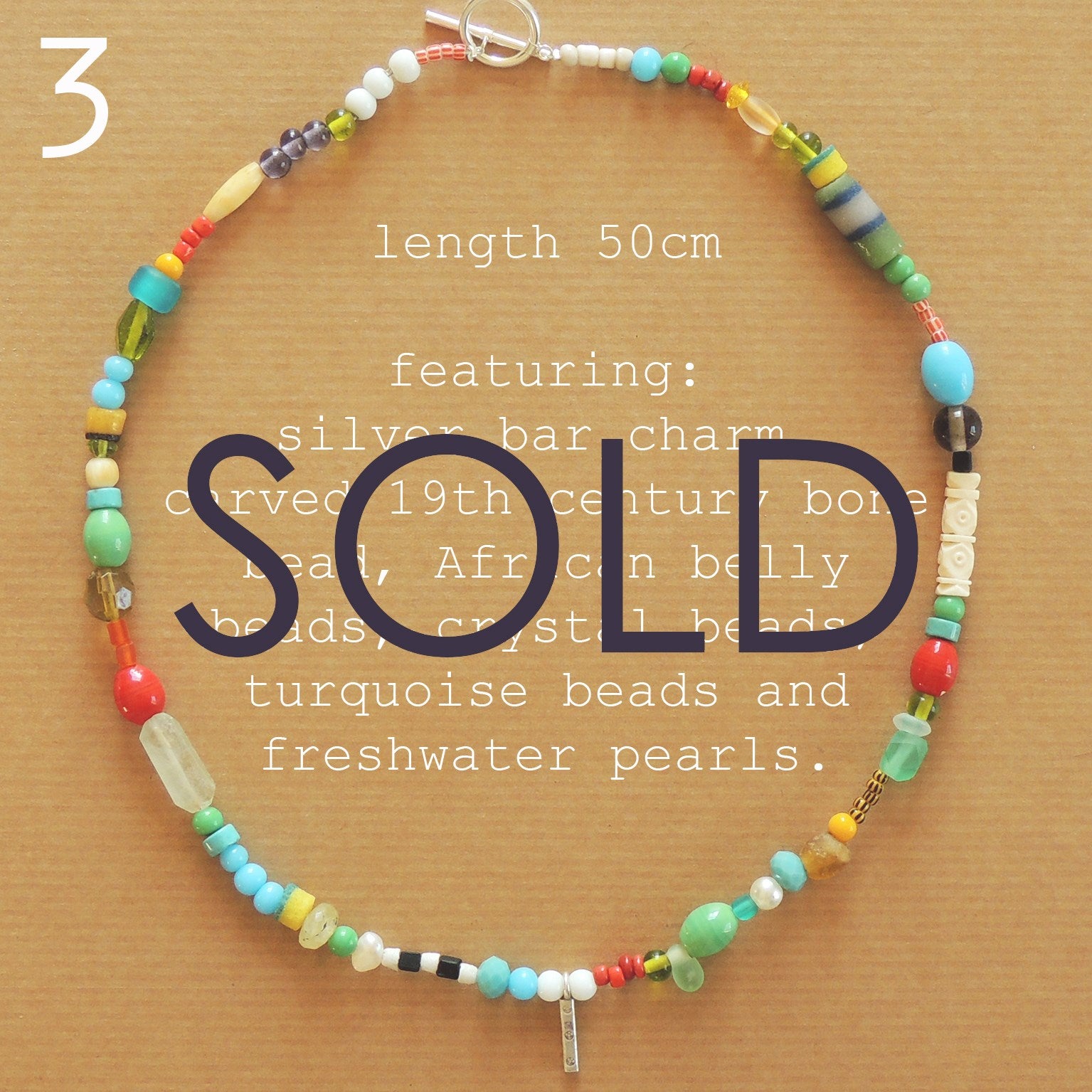 beaded necklace featuring silver bar charm